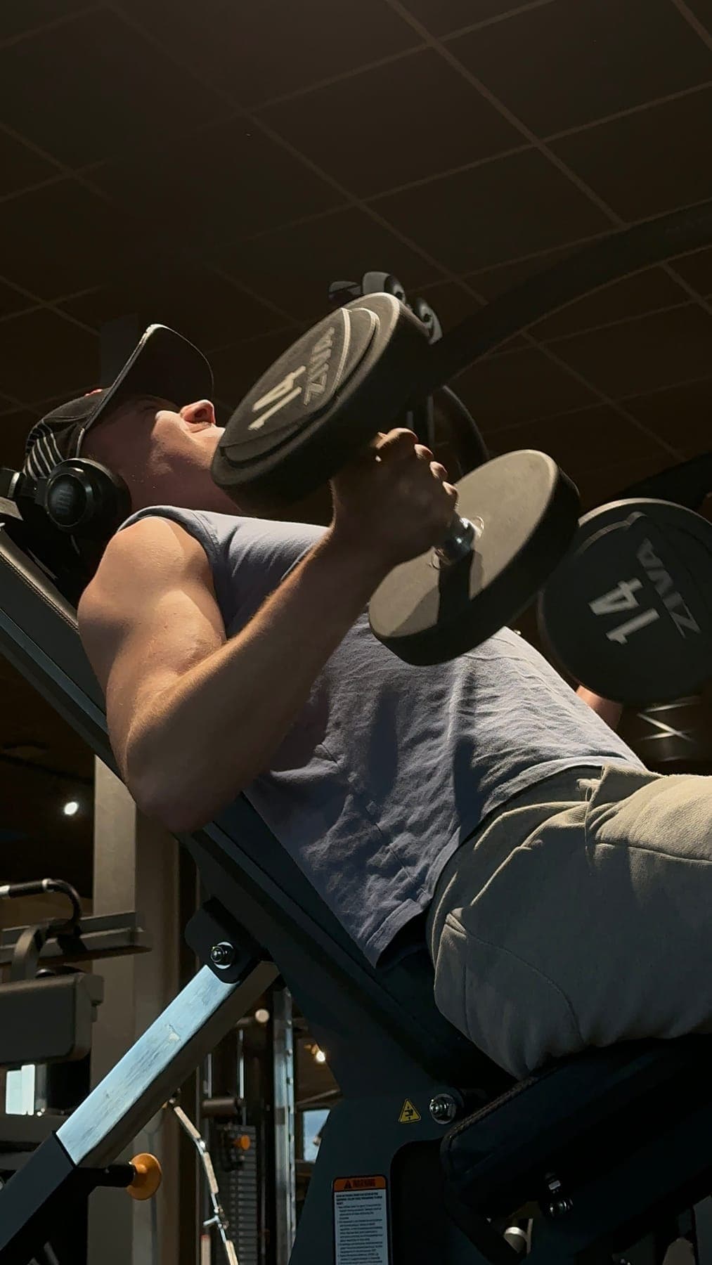 Semyon training with dumbbells in the gym.